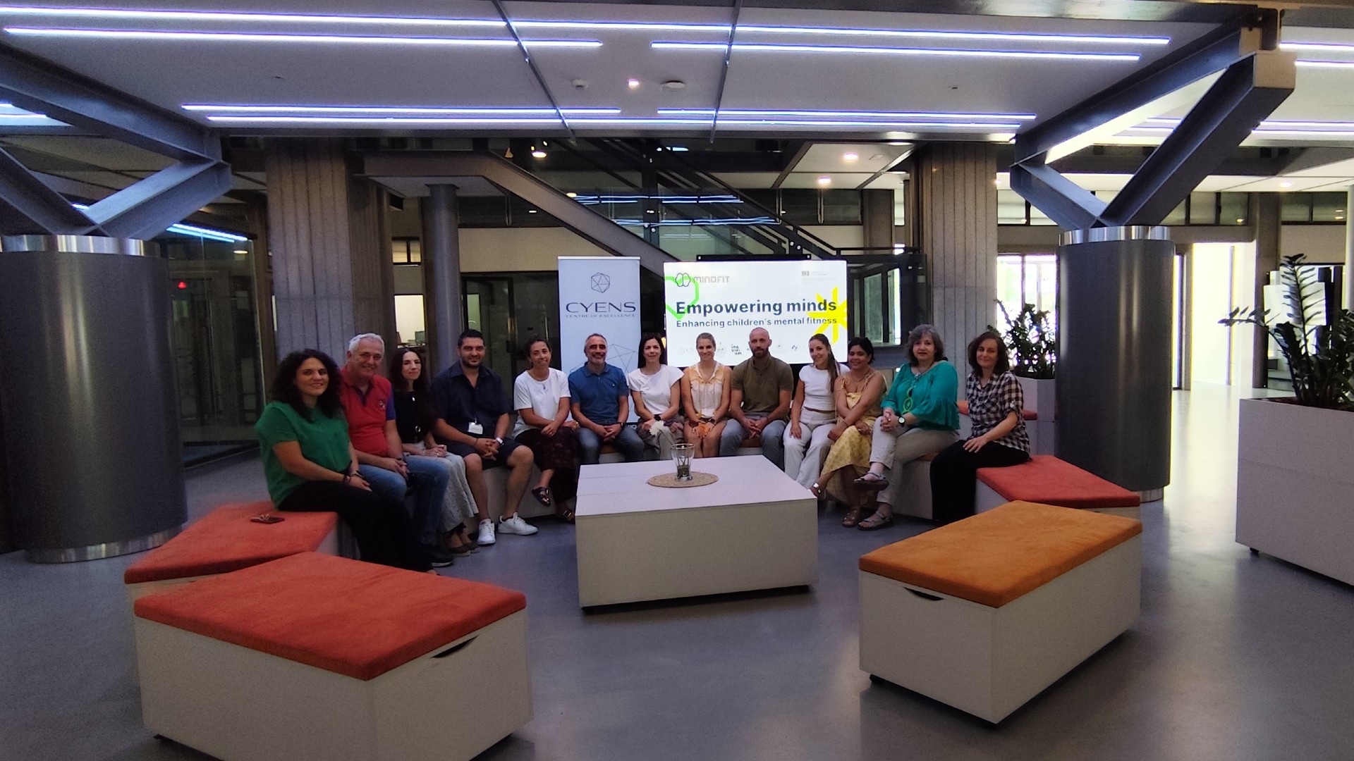 Representatives from the partner organisations of the Mindfit project sitting and smiling at the camera.