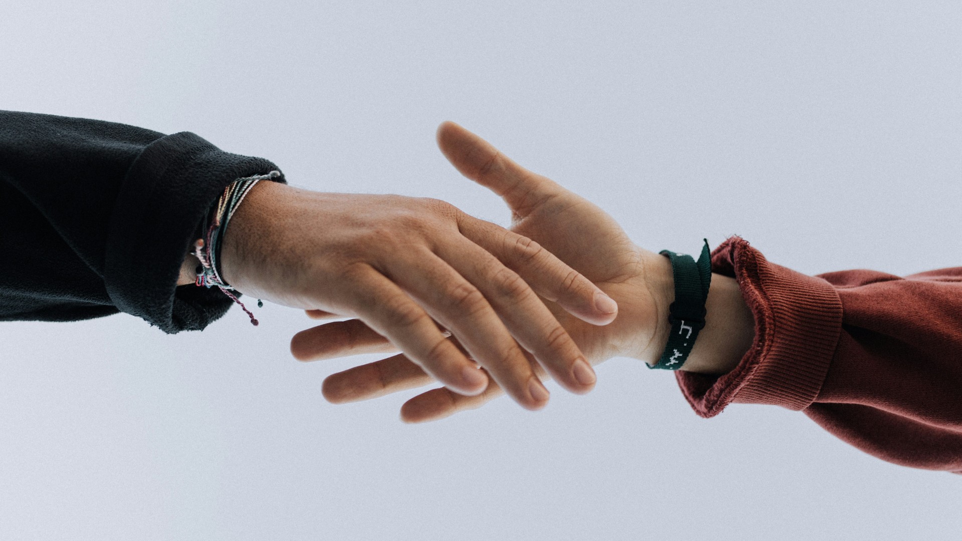 Two hands about to shake as a way to salute one another.